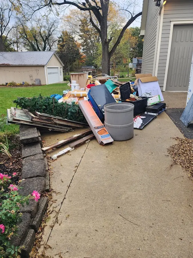 Dumpster being loaded with debris for Commercial Dumpster Rental in Newton